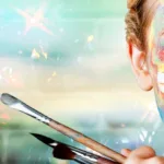Woman with various paint splotches on her face holding paintbrushes to market herself as a copywriter