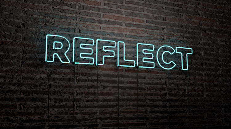 A neon sign that reads "reflect" that is mounted on a brick wall. The color of the sign is neon white.