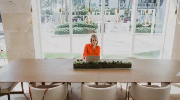 Nicki Krawczyk sitting in an empty conference room.