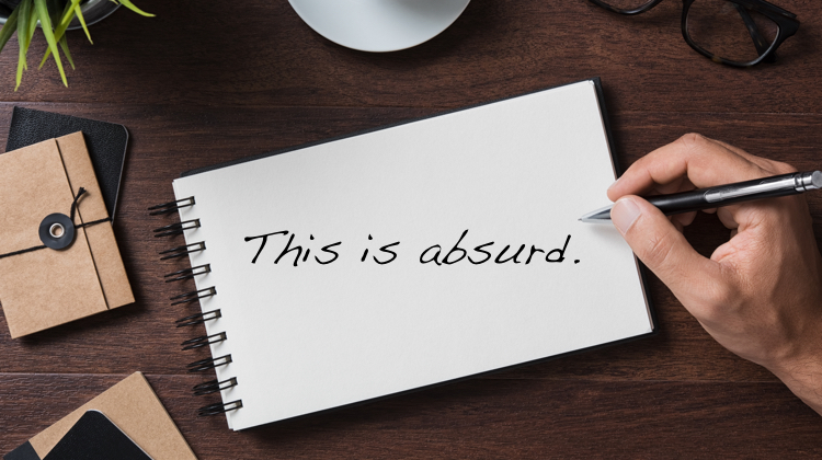 "This is absurd" is written on a notebook that is on a desk; hand copying ads is not an effective method for learning to write copy. Analyzing and rewriting ads is.