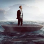 A man standing in a boat in water.