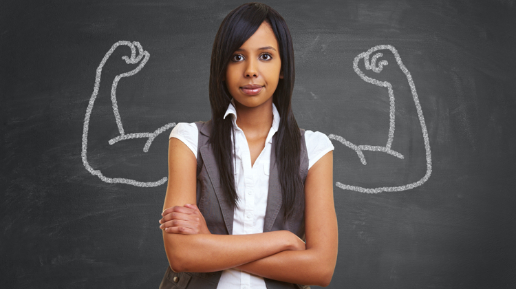 Woman in front of a chalkboard that has strong arms drawn on it.