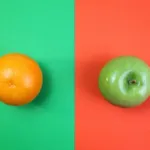 Image is divided down the middle with the left showing an orange (fruit) on a green background and the right showing a green apple on a red-orange background.