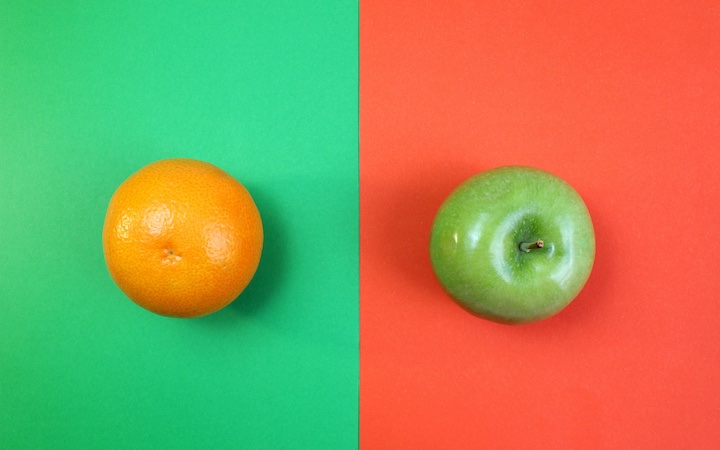Image is divided down the middle with the left showing an orange (fruit) on a green background and the right showing a green apple on a red-orange background.