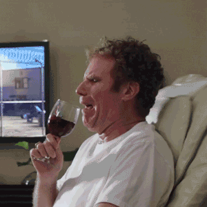 Man crying while drinking red wine in a recliner.