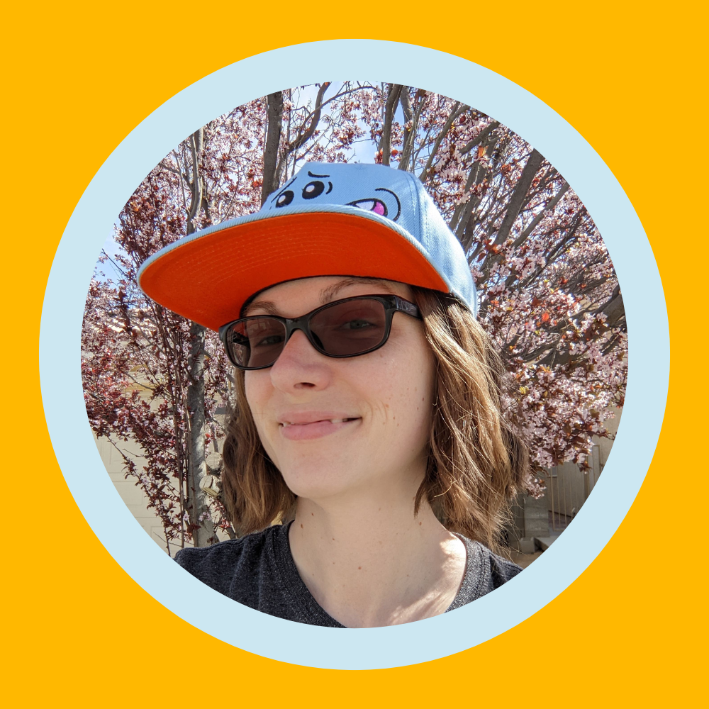 Headshot of Amy, a coach in the CCA copywriting course, wearing sunglasses and a trucker hat.