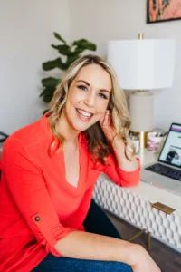 Image of Nicki Krawczyk sitting at her desk, one of the hosts of the Build Your Copywriting Business podcast.